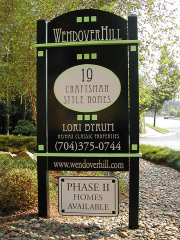 The same sign, upgraded with a black base and lime green accents, with type set in beige and black that announces 19 additional homes being added to the neighborhood