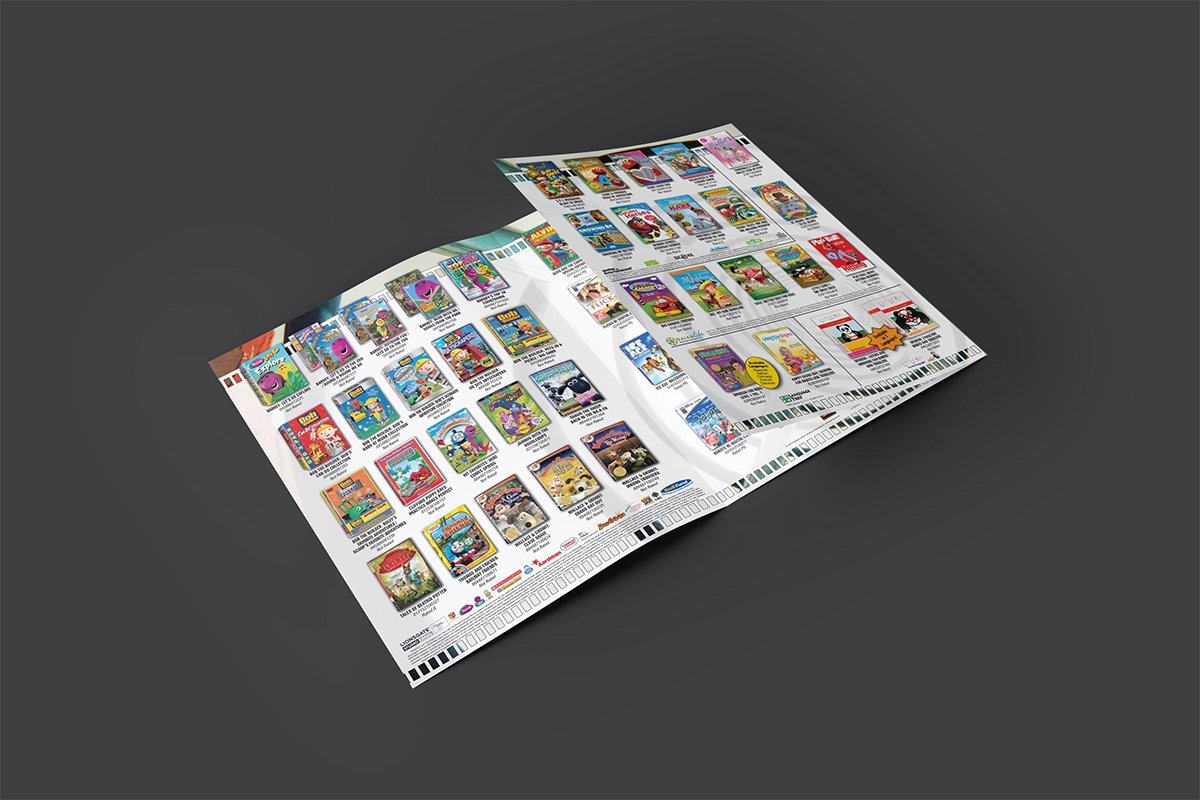 A mockup of a trifold catalog featuring titles for kids. The cover shows a child looking through a ubmarine-style portal on a playground toy, and the other panels feature playground imagery including sidewalk chalk and swings.